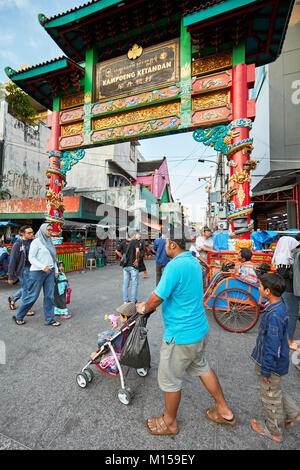 People walking along Malioboro street at the intersection with Kentandan Wetan street. Yogyakarta, Java, Indonesia. Stock Photo