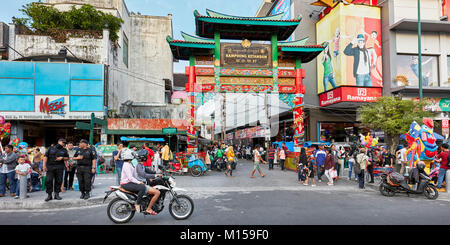 People walking along Malioboro street at the intersection with Kentandan Wetan street. Yogyakarta, Java, Indonesia. Stock Photo