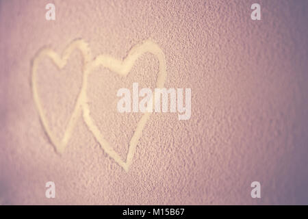 Two hearts, drawing on the snowy background, abstract pink background, heart to heart, romantic message for Valentines day, love concept Stock Photo