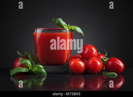 Closeup of a bloody Mary cocktail garnished with a basil on a black background. Copy space. Stock Photo
