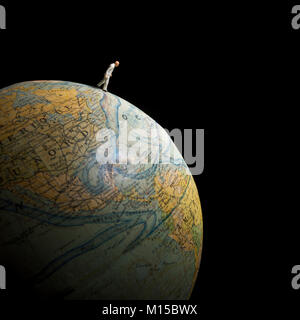 Figurine walking on globe, concept earth Stock Photo