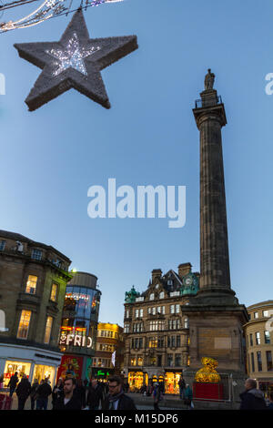 Newcastle, England - December 31, 2017: People around Grey's Monument on Christmas decorated Grey Street in Newcastle at dusk on New Year's eve Stock Photo