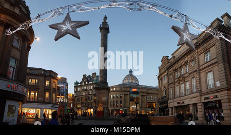 Newcastle, England - December 31, 2017: People around Grey's Monument on Christmas decorated Grey Street in Newcastle at dusk on New Year's eve Stock Photo