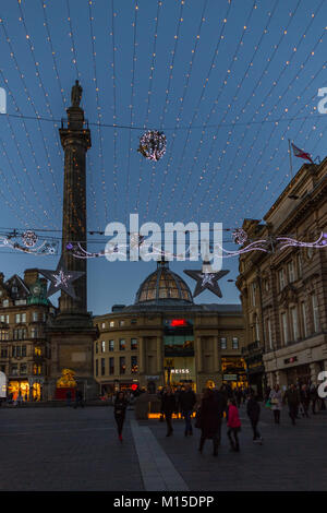 Newcastle, England - December 31, 2017: People around Grey's Monument on Christmas decorated Grey Street in Newcastle at dusk on New Year's eve Stock Photo