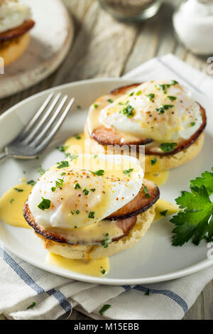Homemade Eggs Benedict with Bacon and Hollandaise Sauce Stock Photo