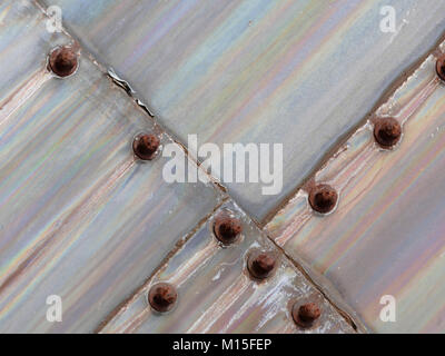 Bolted on Iridescent Metal Slabs in a Line Stock Photo