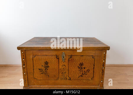 Old wooden chest with closed lit in empty room Stock Photo