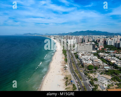 Drone photo of Barra da Tijuca beach, Rio de Janeiro, Brazil. We can see the beach, some building, the boardwalk, the road and the horizon Stock Photo