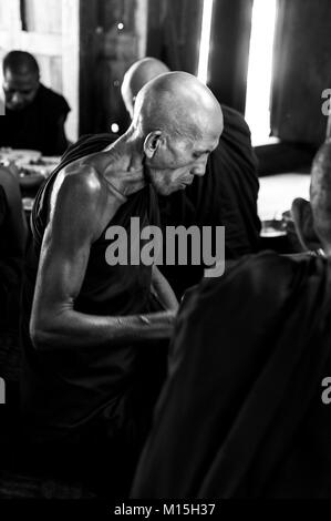 BAGAN, MYANMAR - NOVEMBER, 2016: Monks in a monastery near Mandalay preparing for lunch. Stock Photo