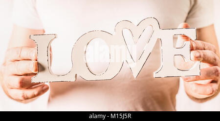 Male hands holding word Love on light background, close up Stock Photo