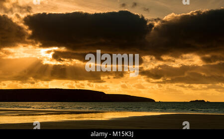 Sunbeams at sunset over the beach at Broad Haven on the Welsh coast Stock Photo