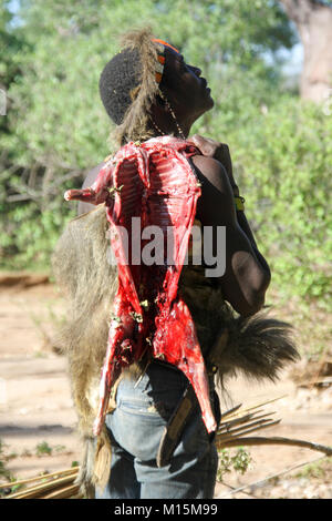 Hadza, or Hadzabe man hunting with bow and arrow Photographed at Lake Eyasi, Tanzania Stock Photo