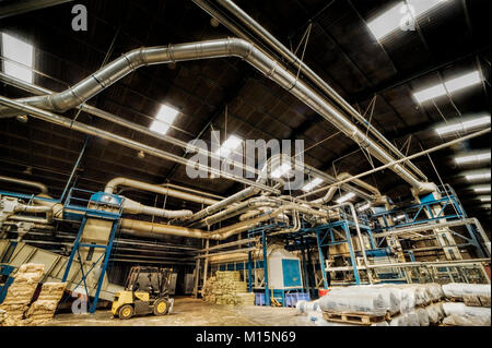 Air conditioning and dust control pipework in a UK plant processing hemp fibre. Stock Photo