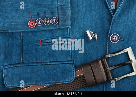 Elegant denim suit with a silver cufflinks and belt. Male jacket with cufflinks and pockets, close-up. Men's fashion. View from above. Stock Photo