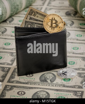 Simulated bitcoins on many two dollar bills with a wallet filled with money Stock Photo