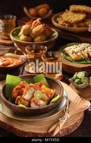 Batagor, the Sundanese Snack of Fried Fish Dumplings, Bean Curd, and Wonton with Spicy Peanut Sauce Stock Photo