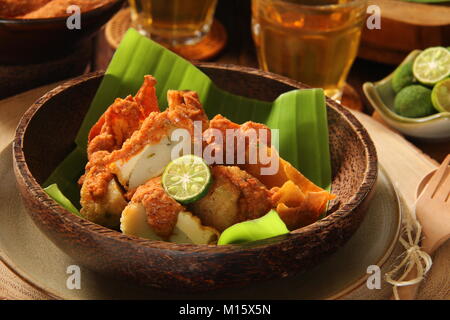 Batagor, the Sundanese Snack of Fried Fish Dumplings, Bean Curd, and Wonton with Spicy Peanut Sauce Stock Photo