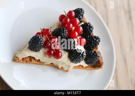 Beautiful photo of delicious cheese cheesecake with blackberries and red currants close up Stock Photo