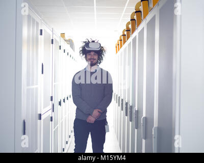 young IT engeneer using virtual reality headset over server room background Stock Photo