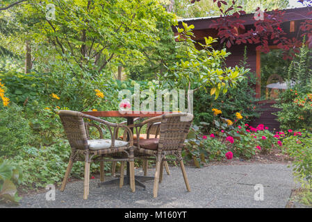 One of the beautiful garden patio tables at Linden Gardens, a popular Okanagan destination for weddings and tourism in Kaleden, BC, Canada. Stock Photo