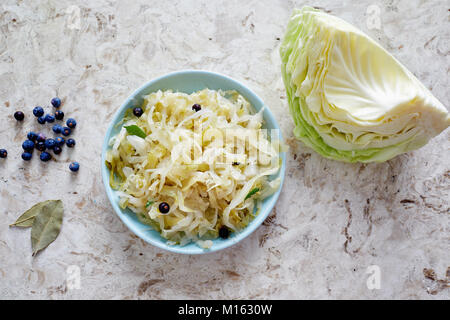 Sauerkraut in a small dish. Sauerkraut with juniper berries. Stock Photo