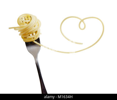 Swirls of cooked spaghetti with fork. Spaghetti heart shape. Stock Photo