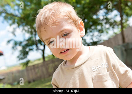 Blonde child with blue eyes, outdoor, portraits. The boy is four years old and is happy, having fun! Stock Photo