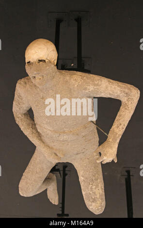 One of twenty cast preserved victims from the mount Vesuvius eruption in 79 A.D. a inside plywood pyramid, Pompeii, Campania, Italy. Stock Photo