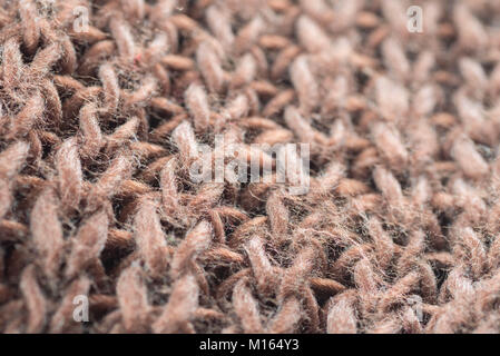 brown knitwear woolen textile texture background  macro selective focus Stock Photo