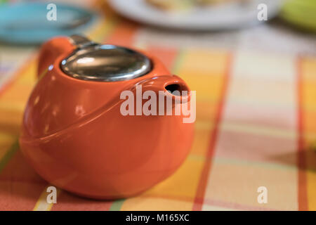 Orange brewer, stands on a table covered with a checkered tablecloth Stock Photo