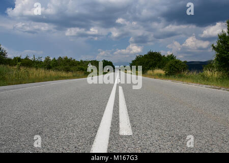 Empty asphalt country road with Stock Photo