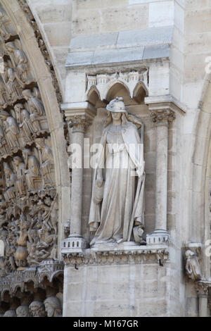 Statue 3rd from the left near an entrance on the Western facade of the Notre Dame Cathedral, Paris, France. Stock Photo