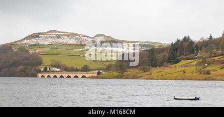 An image of a road bridge crossing over Ladybower Reservoir, with snow lying on the hills behind, Derbyshire, England, UK Stock Photo