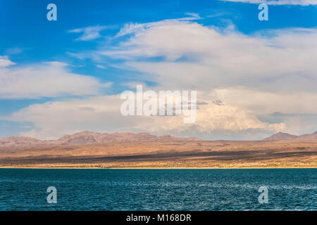 Ripples of water with mountain range in the horizon and a bright blue sky, Lake Mead, Nevada, summer. Stock Photo