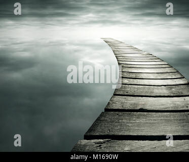 Beautiful conceptual background with a wooden path in to the infinity dramatic sky Stock Photo