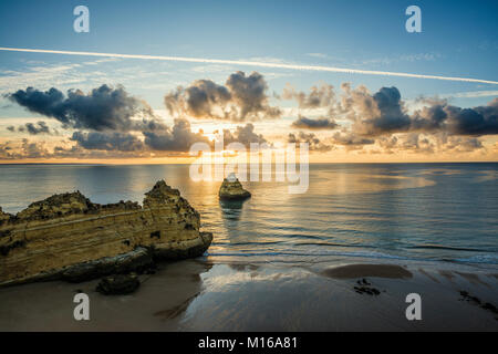 Coloured cliffs and sunrise at the beach, Praia da Dona Ana, Lagos, Algarve, Portugal Stock Photo