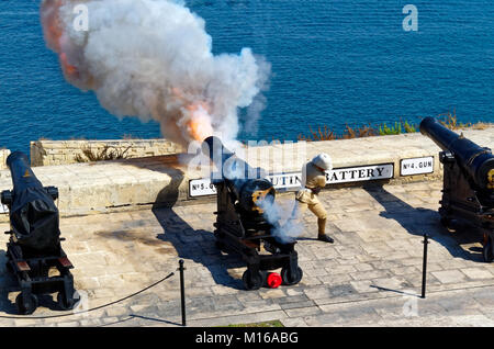 Gunfire from a gun at noon in Saluting Battery at Fort Lascaris, view from Upper Barrakka Gardens, Valletta, Malta Stock Photo