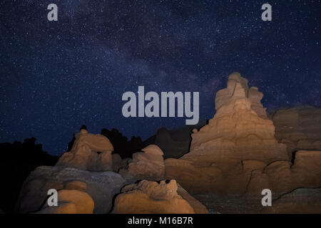 Goblins or hoodoos eroded from Entrada Sandstone, photographed at night with the stars and Milky Way overhead, in Goblin Valley State Park, Utah, USA Stock Photo