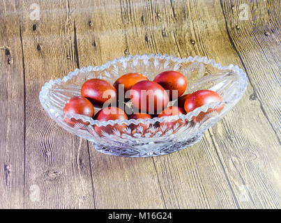 Painted Easter eggs in a crystal vase. Red painted chicken eggs for easter Stock Photo