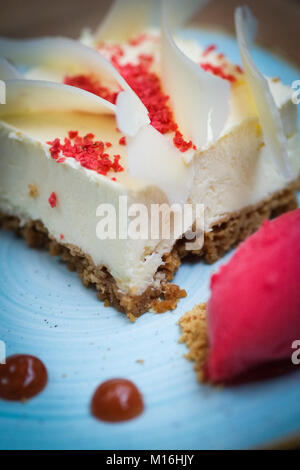 White chocolate and raspberry cheesecake, with raspberry sorbet Stock Photo