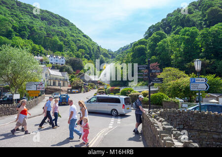 Lynmouth, Devon. Town Centre with tourists in summertime. View up Glen Lyn Gorge with water Jets Stock Photo