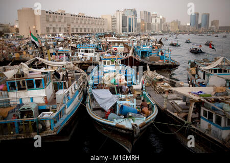 DUBAI, UNITED ARAB EMIRATES - October 17, 2008: Iranian dhow boats line the river bank of the Dubai Creek, waiting to load or unload cargo. Stock Photo