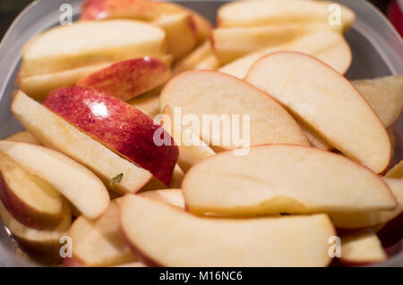 Apple slices in plastic container Stock Photo