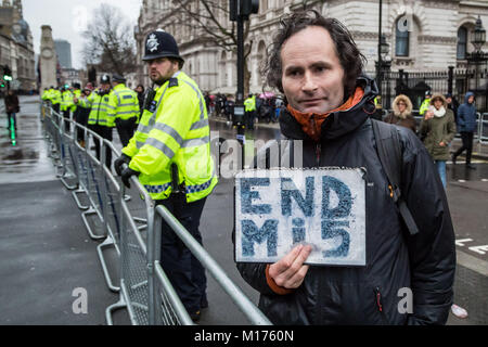 Downing Street, London, UK. 27th Jan, 2018. A lone protestor outside Downing Street gates holds a sign that reads 'END Mi5' referring to the United Kingdom's domestic secret intelligence agency. Credit: Guy Corbishley/Alamy Live News Stock Photo