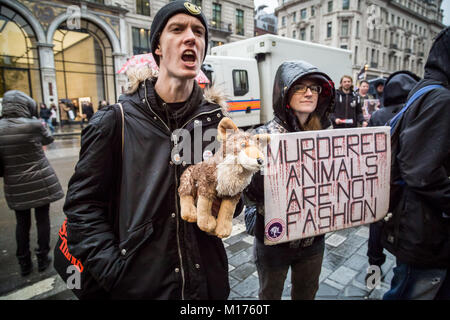 London, UK. 27th January, 2018. Animal rights protesters continue their weekly demonstrations outside the Canada Goose flagship store on London’s Regent Street. The Canadian brand has faced global criticism for producing parka jackets with a trim made from coyote fur, which animal rights group PETA claim are caught in the wild in steel traps. © Guy Corbishley/Alamy Live News Stock Photo