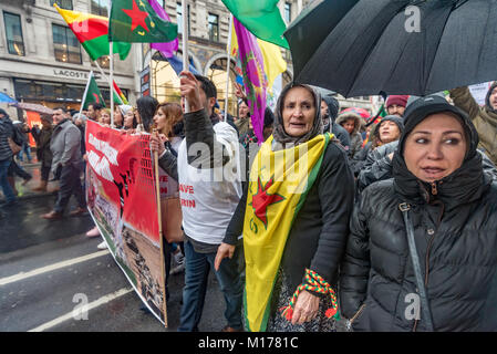 London, UK. 27th January 2018. Several thousand people, mainly Kurds, march through London from outside the BBC to a rally opposite Downing St, calling for an end to the attacks by Turkish forces on the Afrin Canton of Northern Syria, now a part of the Democratic Federation of Northern Syria (DFNS) or Rojava,  a de facto autonomous region in northern Syria. The area is one of the most peaceful in Syria and with a constitution that includes equality of treatment for all ethnic groups ds. Credit: Peter Marshall/Alamy Live News Stock Photo