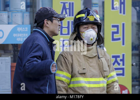 Miryang, Gyeongnam, South Korea. 26th Jan, 2018. Jan 26, 2018-Miryang, South Korea-South Korean Fire fighter hear from native about fired situation at near blaze hospital in Miryang, south Korea. A fire gutted the ground floor of a hospital in southeastern South Korea and sent toxic fumes raging through the six-story building, killing at least 37 people and injuring 131 others in one of the country's deadliest blazes in a decade. Nearly 180 people were inside Sejong Hospital in Miryang, some 380 kilometers southeast of Seoul, when the fire broke out around 7:30 a.m. Witnesses said they fi Cred Stock Photo