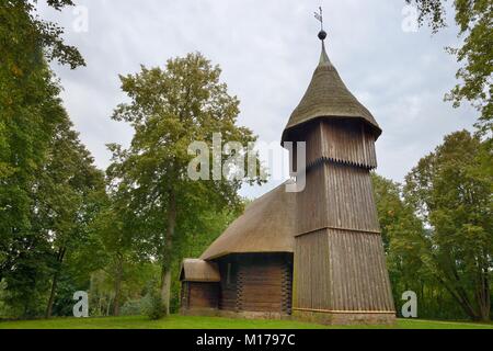 Old wooden church and belfry with thatched roofs from Masuria, now within the Ethnographic Park, Olsztynek, Poland, September 2017. Stock Photo