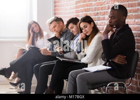 Contemplated Businesspeople Waiting For The Job Interview In Office Stock Photo