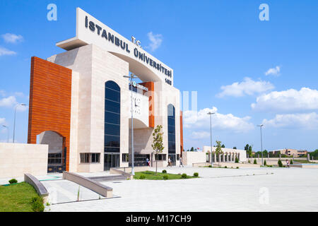 Istanbul, Turkey - June 27, 2016: Main entrance gate of Istanbul University campus in Avcilar. Ordinary people walk nearby Stock Photo